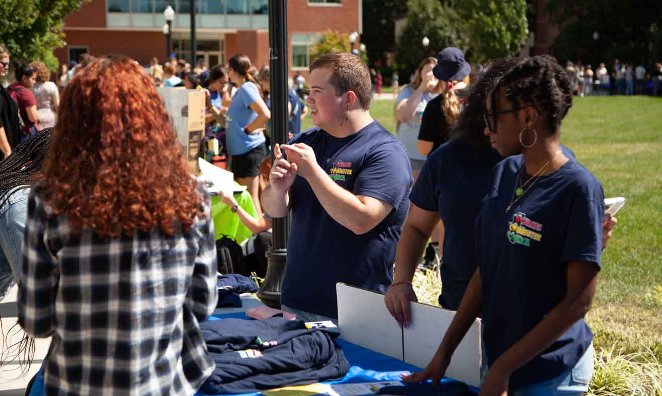 students at an outdoor booth