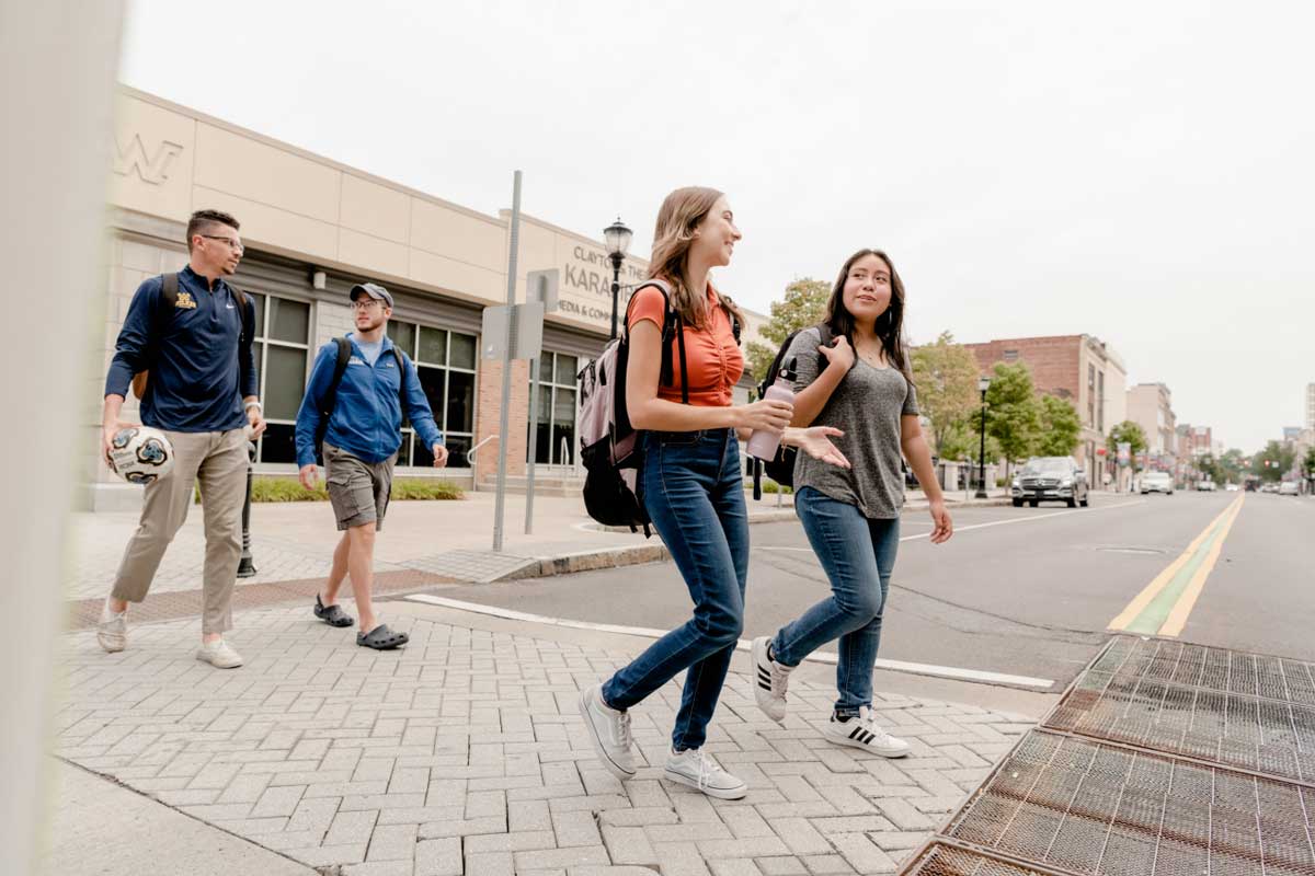 students crossing street and talking