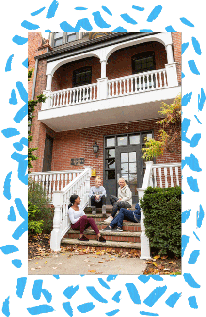 students sitting on residence hall steps