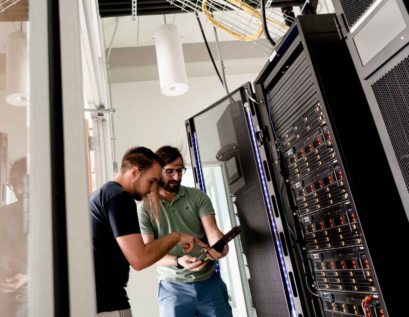 student and instructor working with super computer