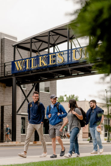 students walking and talking on campus